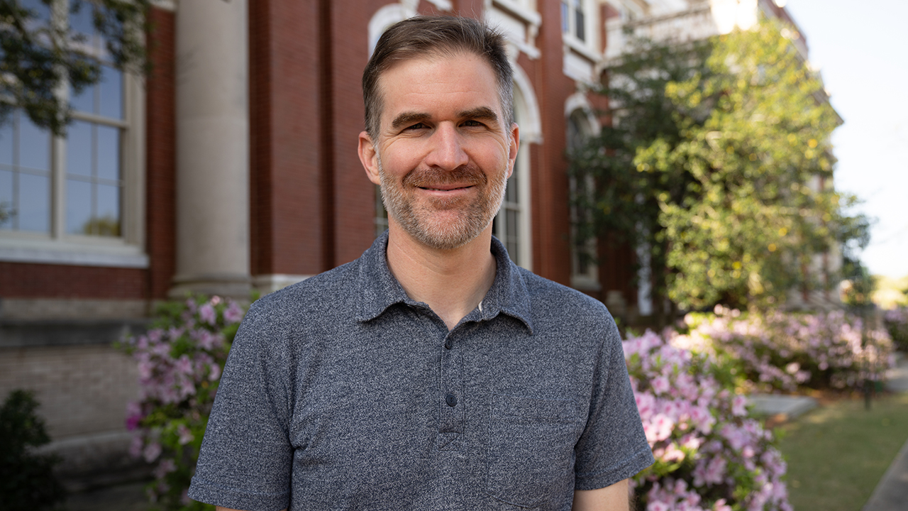 Geoff Williams in front of Comer Hall