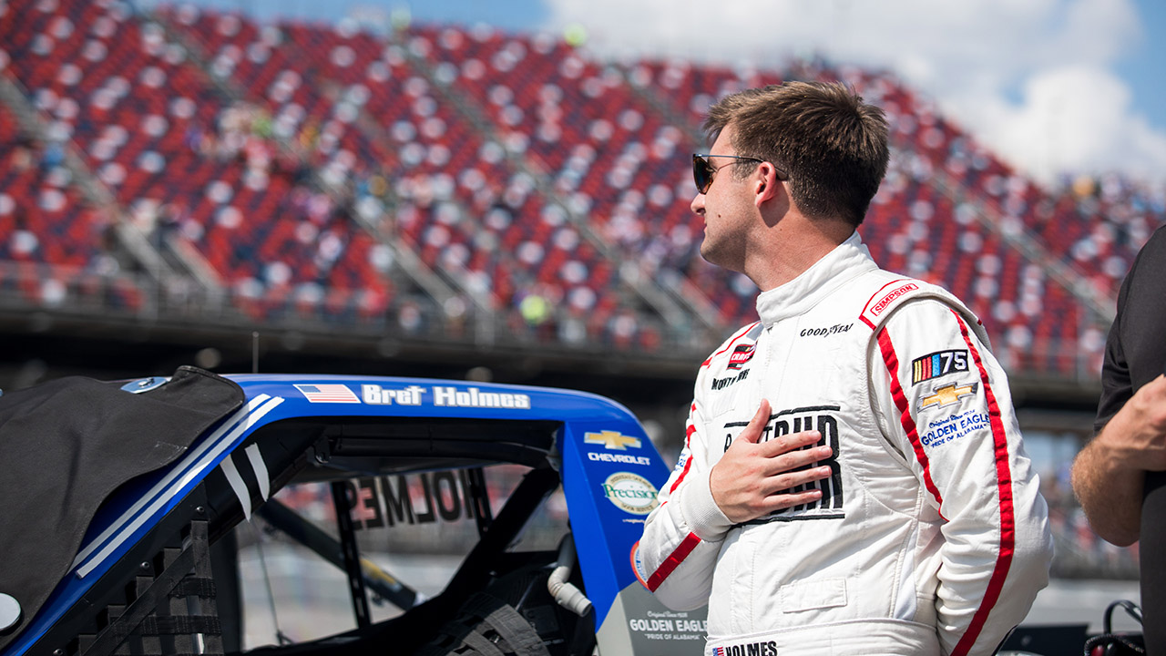 Bret Holmes race car driver looks out over track.