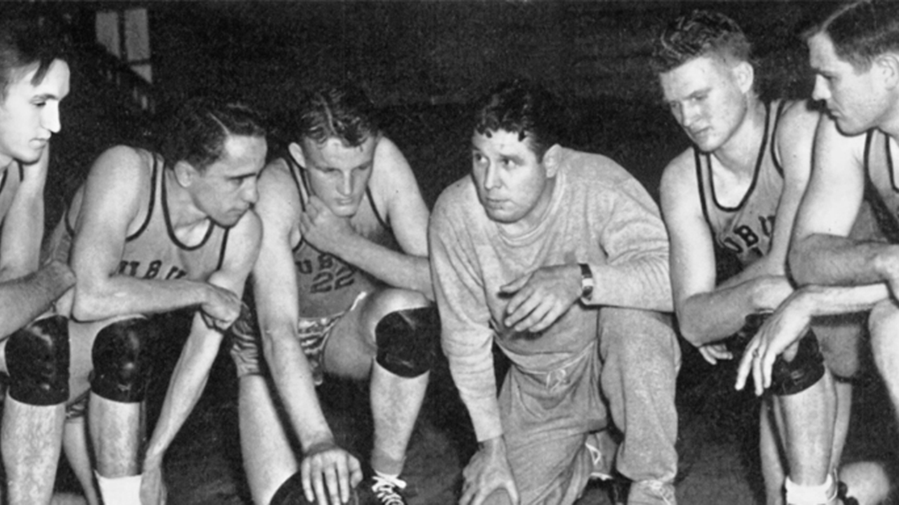 Shug Jordan huddles with members of the Auburn Basketball team. 