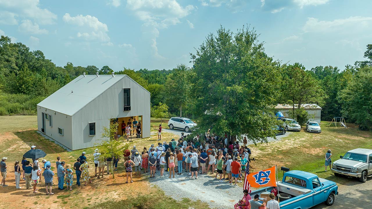 A group of people stand outside a building