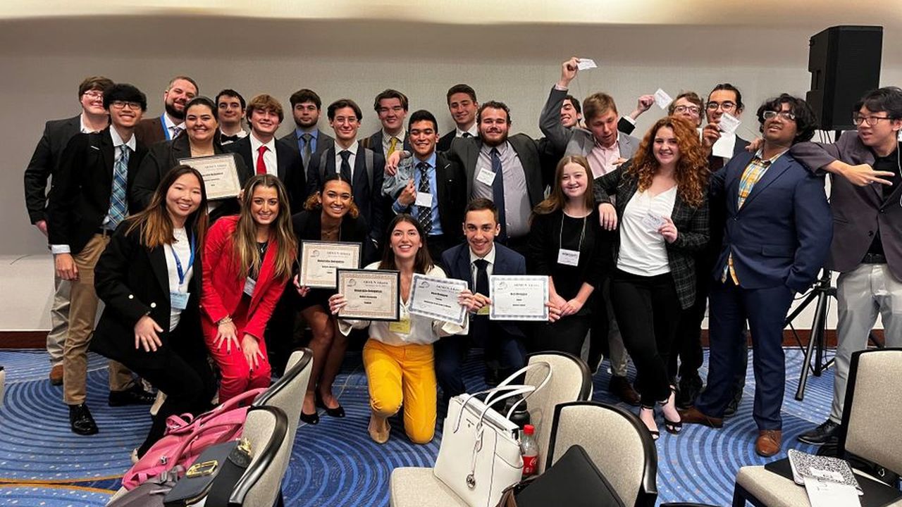 Group of students holding their award certificates