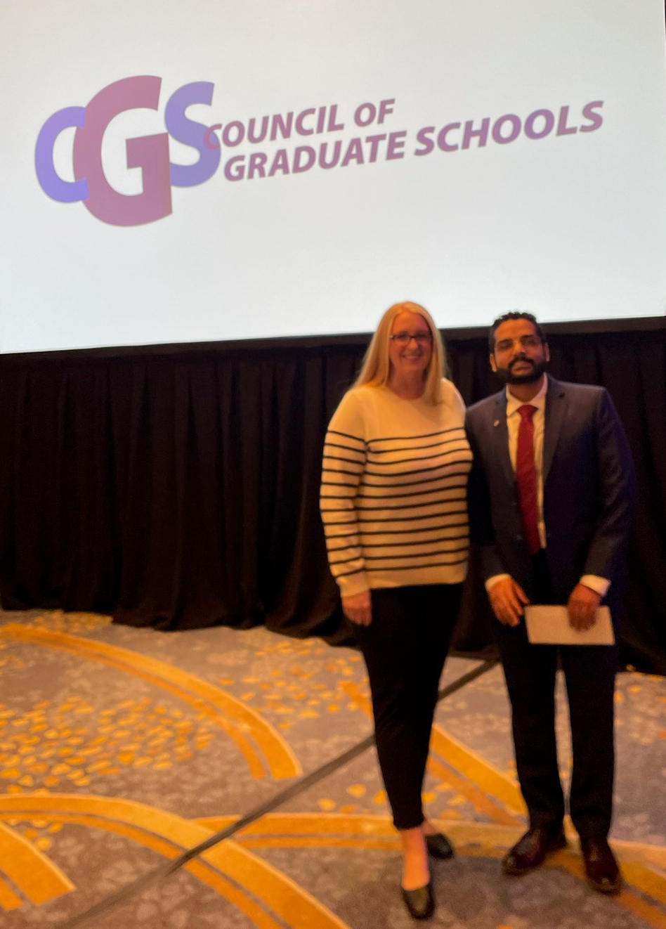 Dr. Sheena Stewart, Dir. of Professional Development at the AU Graduate School, congratulates Dr. Shiva Nageswaran on his win at the national 3MT competition