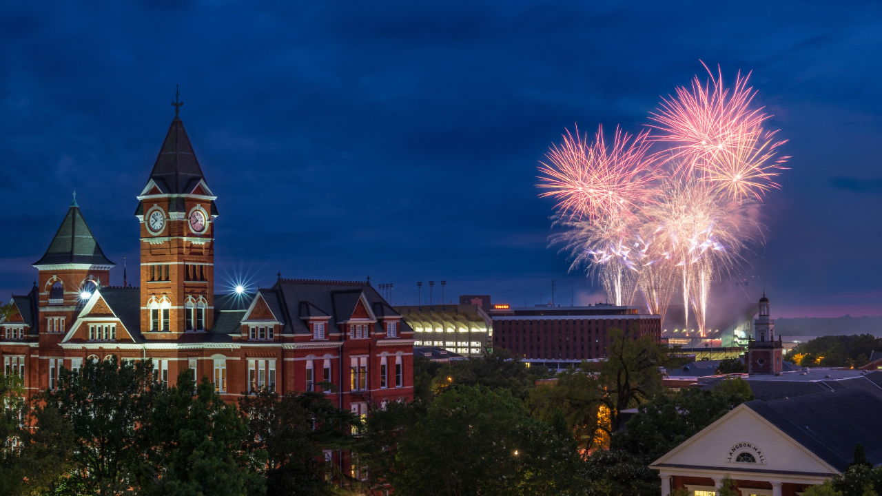 Samford Hall with fireworks in the sky