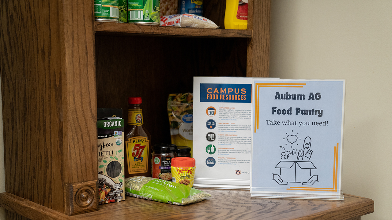 Food pantry shelves hold non-perishable food and signage
