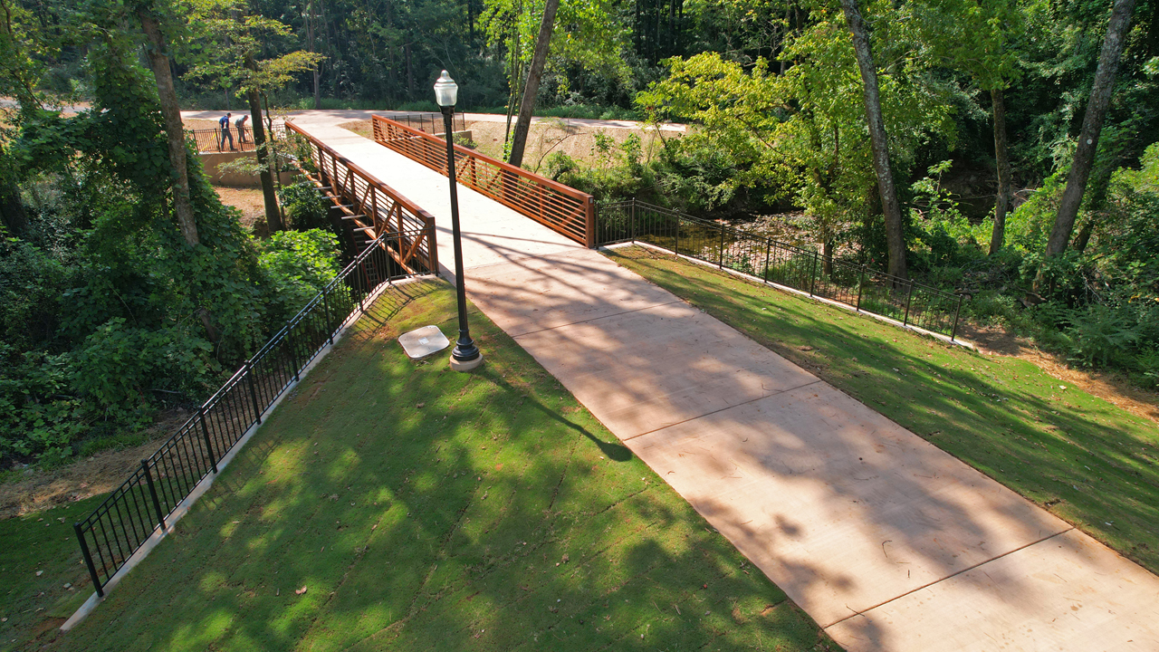 The pre-manufactured truss bridge (span 70-feet) sits across Parkerson Mill Creek, connecting two sections of the Greenway.