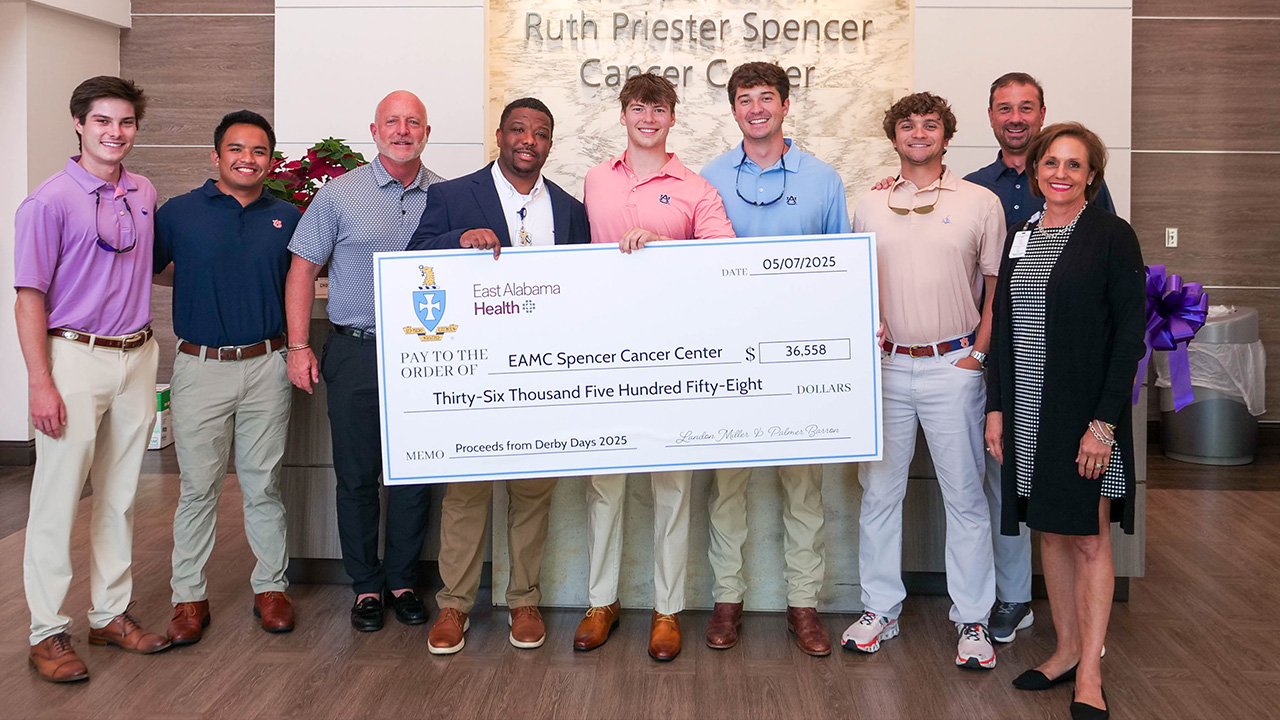 Brothers of Auburn Sigma Chi present a check to East Alabama Medical Center.