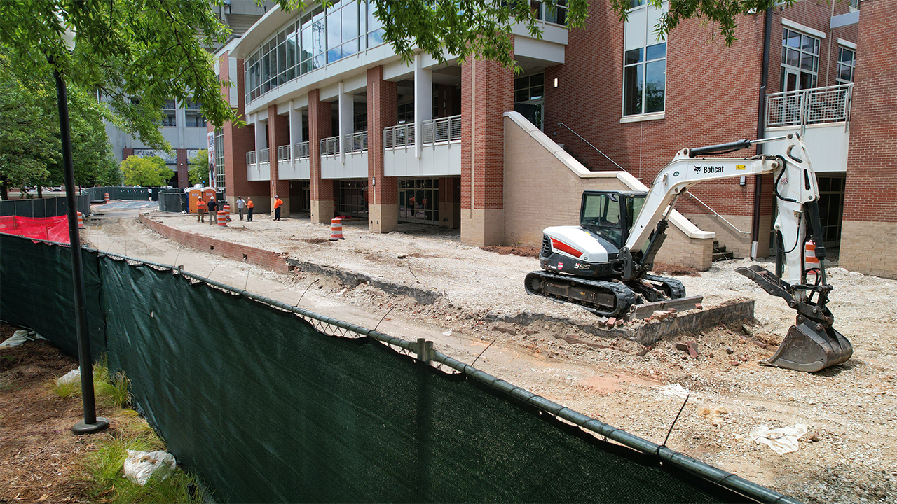 Construction fencing surrounding the Melton Student Center patio renovation.