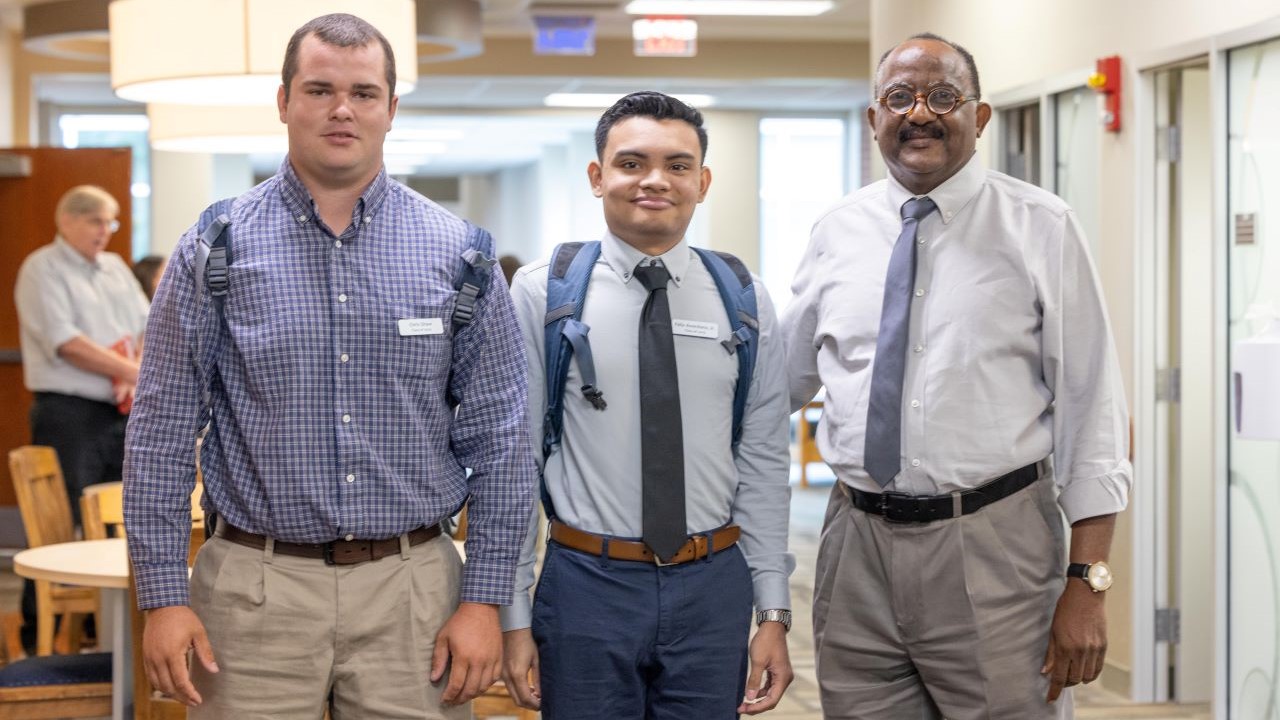 Veterinary Anatomy Professor Mahmoud Mansour (right) visits with a pair of male first-year veterinary students during the Auburn University College of Veterinary Medicine