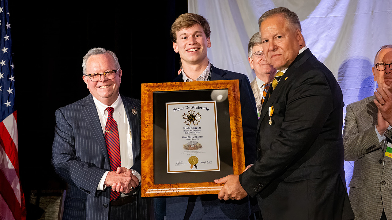 Auburn Sigma Nu Brother, Carter Deriso (center), accepting the Rock Chapter Award from past Sigma Nu National President and Auburn Alumnus Maury D. Gaston ’82 (left) and current Sigma Nu National President Stephen E. Ratterman, Sr. (right)