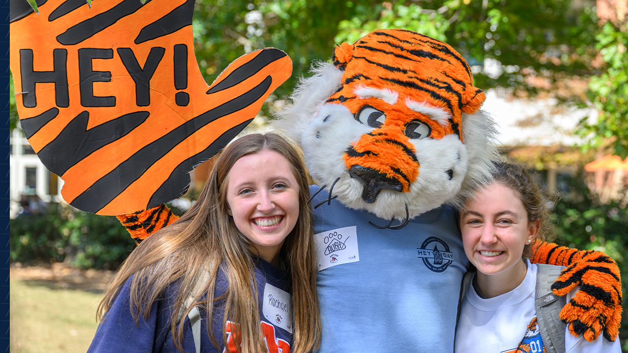Auie poses with students on Hey Day.