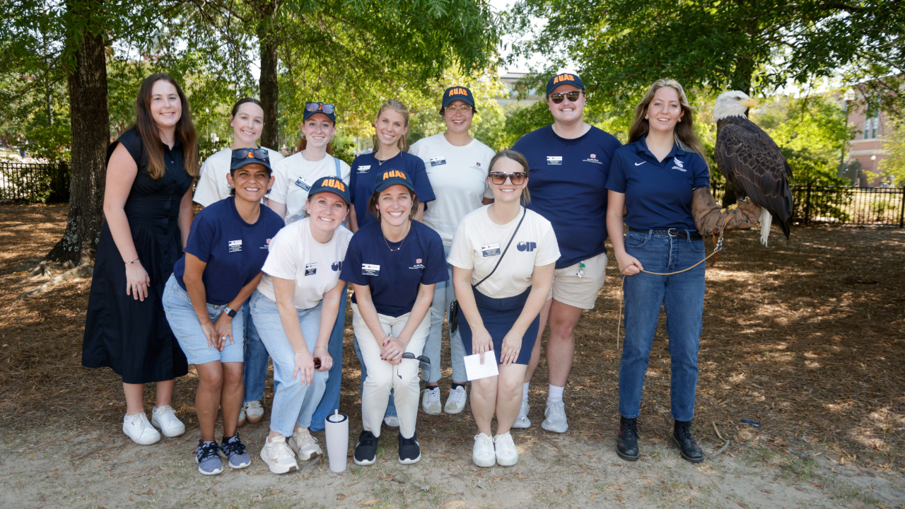The Auburn Abroad Team takes a picture with Independence, one of the eagles from the Auburn University Raptor Center.