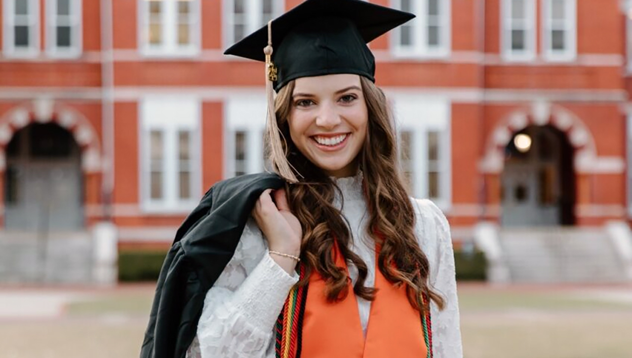 Ashlynn Bara in graduation cap outside Samford Hall