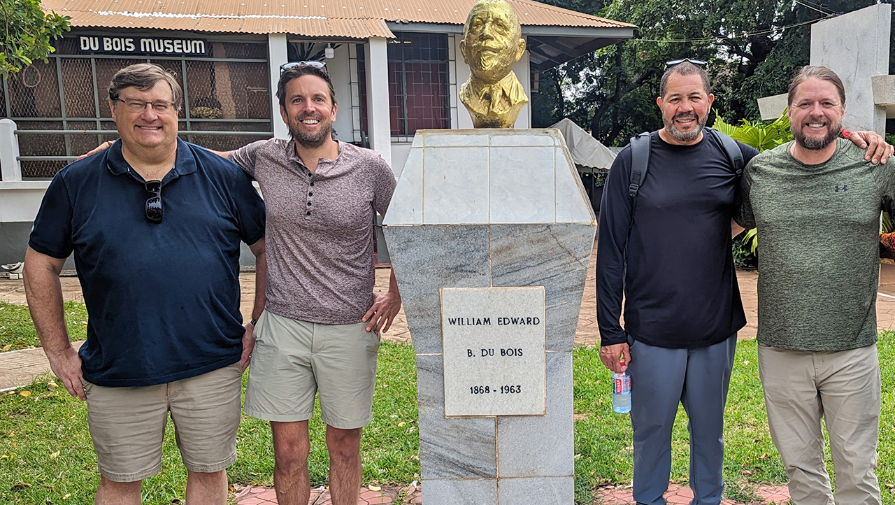 Four male professors in front of museum