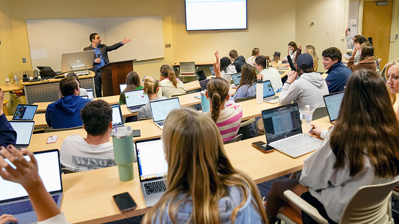 Man conducts software training to students in classrooom