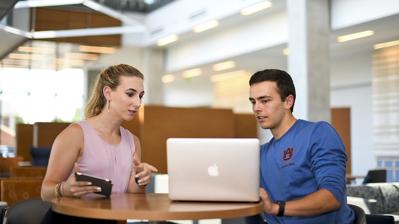 Woman and man student talking at table
