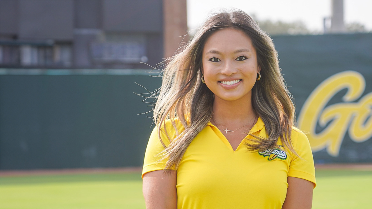 Lian Leduc stands on a baseball field