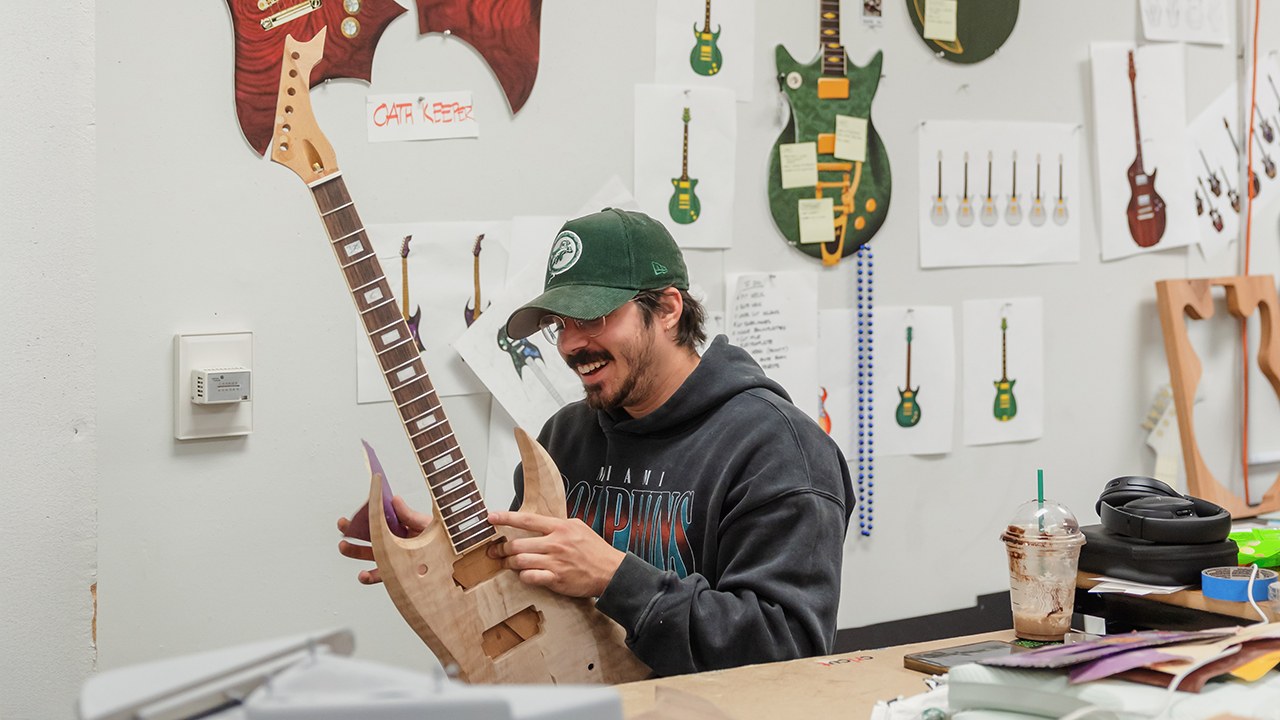Industrial design student working in guitar design studio