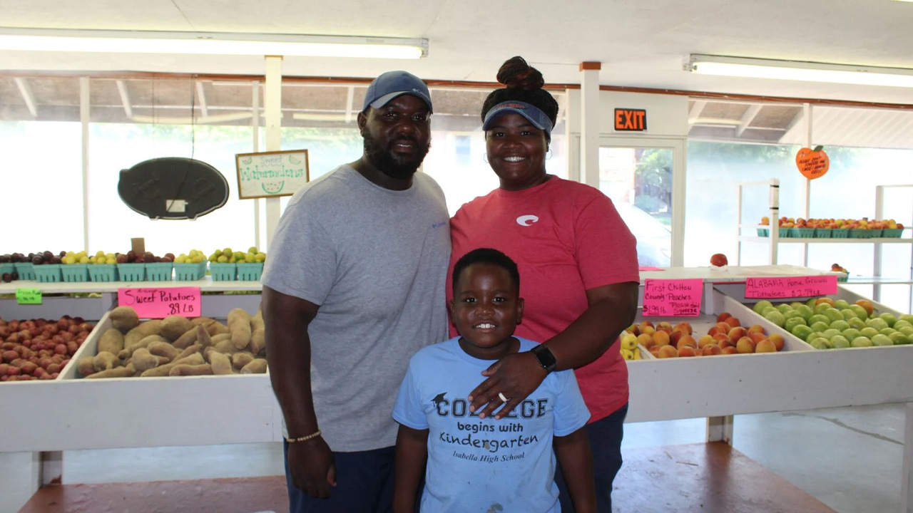 The Ford family stands in a farm field