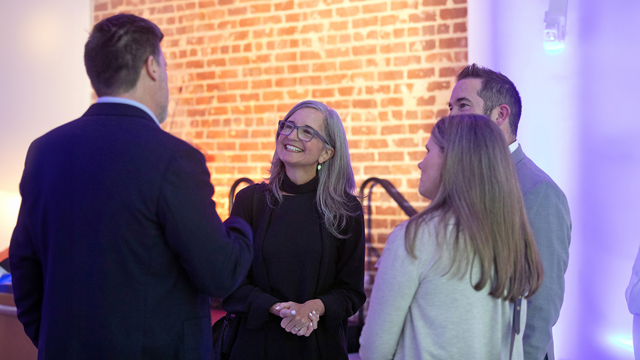 Dean Dawn Finley speaking with alumni at the 2024 Urban Studio Open House 