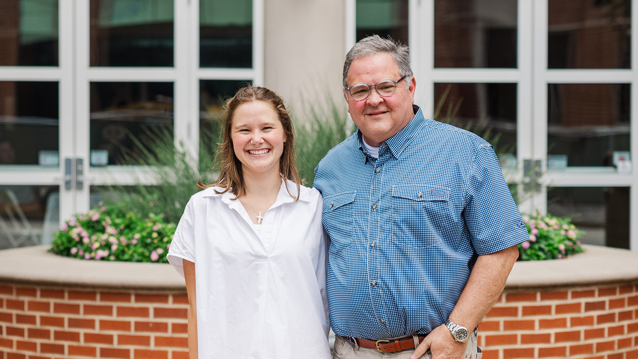 Photo of father and daughter standing together in front of the Gorrie Center