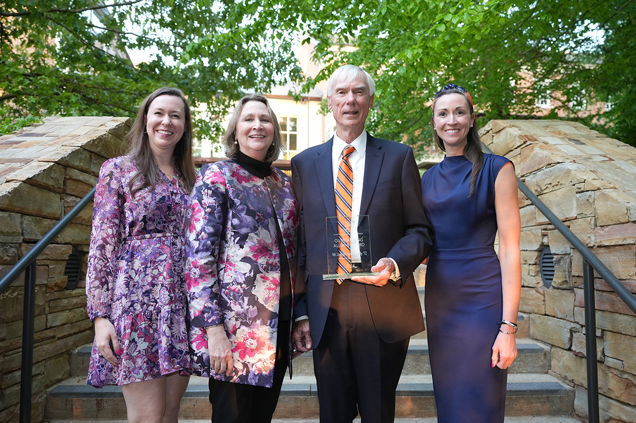 Joe Twardy stands with family at the Auburn College of Forestry, Wildlife and Envrironment holding an award for Outstanding Alumni 2025