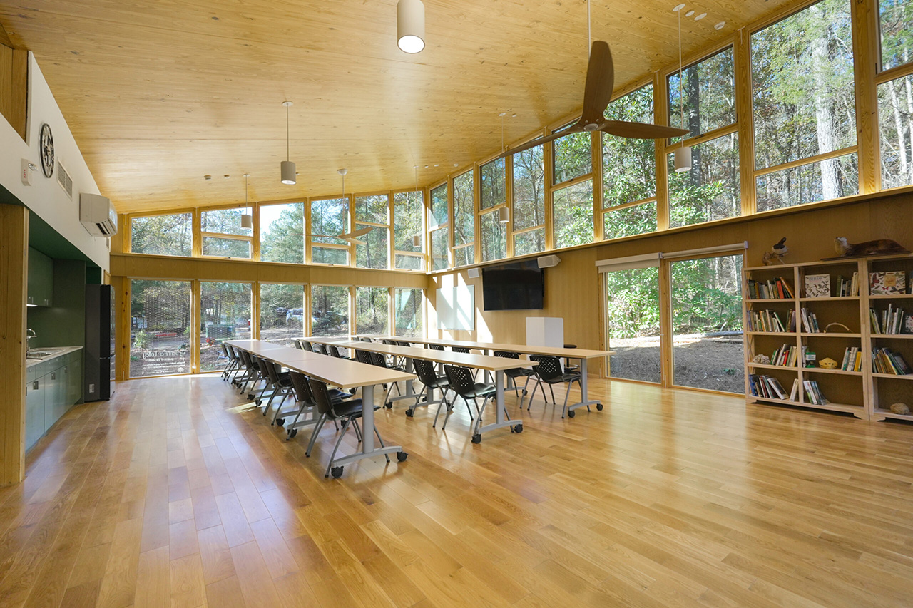 the City of Auburn Classroom features tall windows, a natural light setting, desks, monitors, and natural accents.