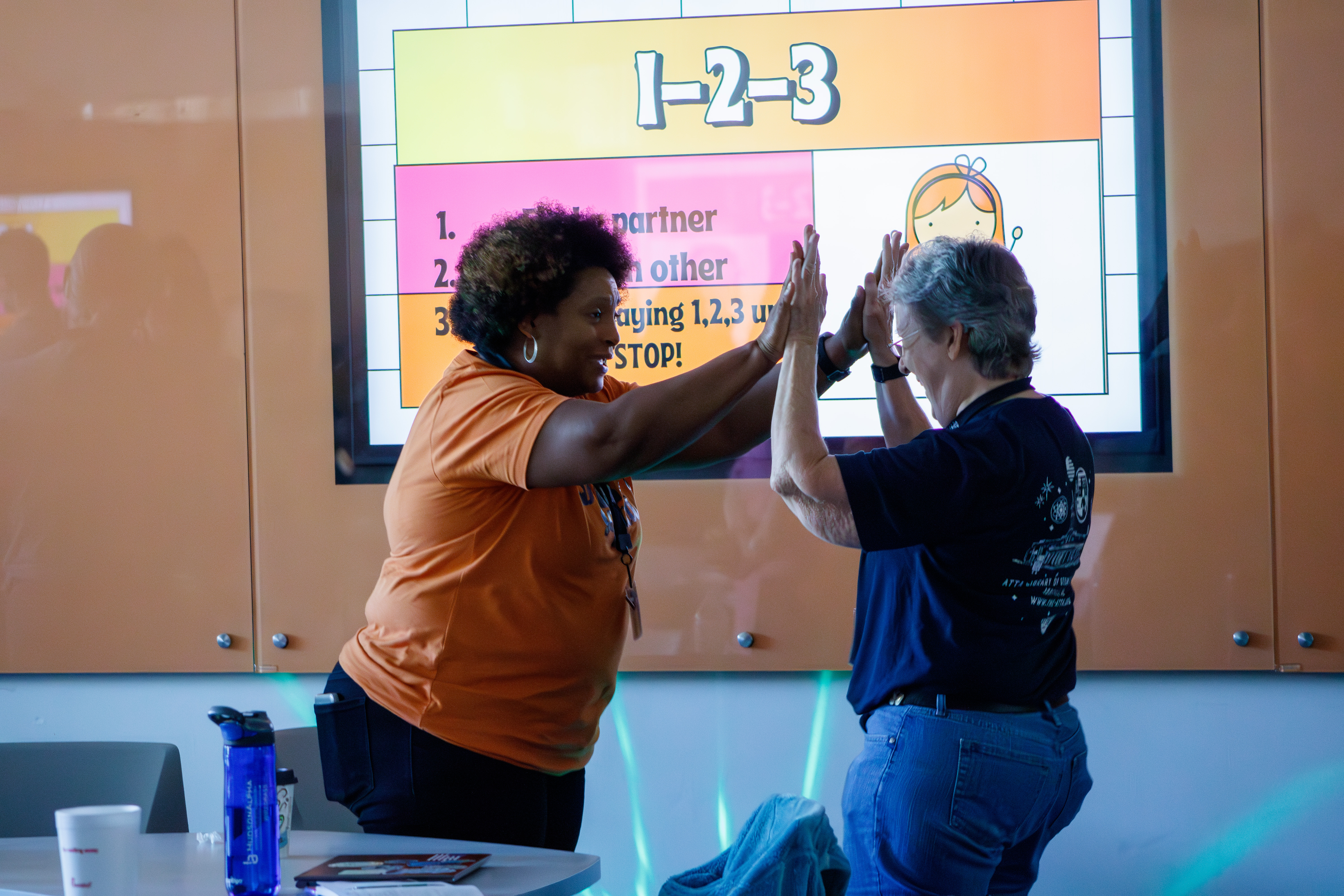 – SERC participants celebrate learning new skills in a coding session.