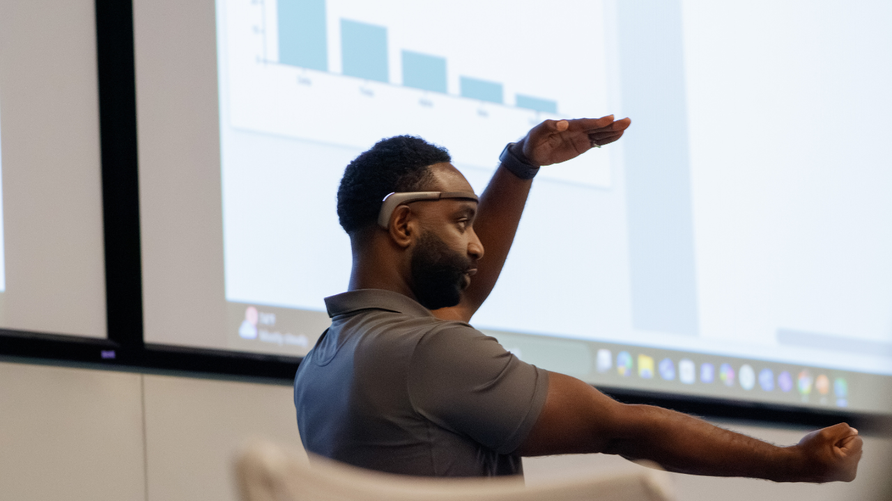 Keynote speaker Chris Crawford demonstrates brainwave-controlled robotics during his presentation at the 2025 SERC conference.