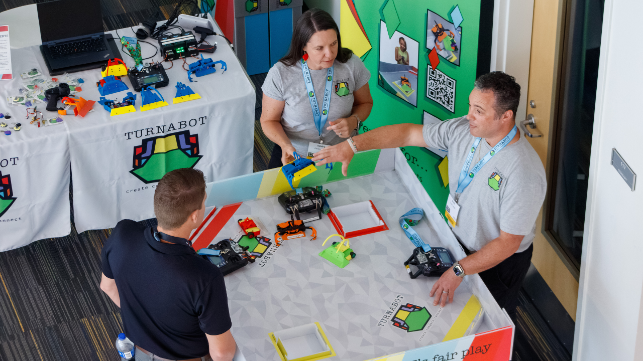 Exhibitors demonstrate Turnabot robots and interactive learning kits during the 2025 Southern Educational Robotics Conference.