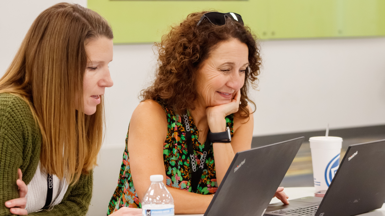 Two educators collaborate on coding exercises during a breakout session at the 2025 Southern Educational Robotics Conference.