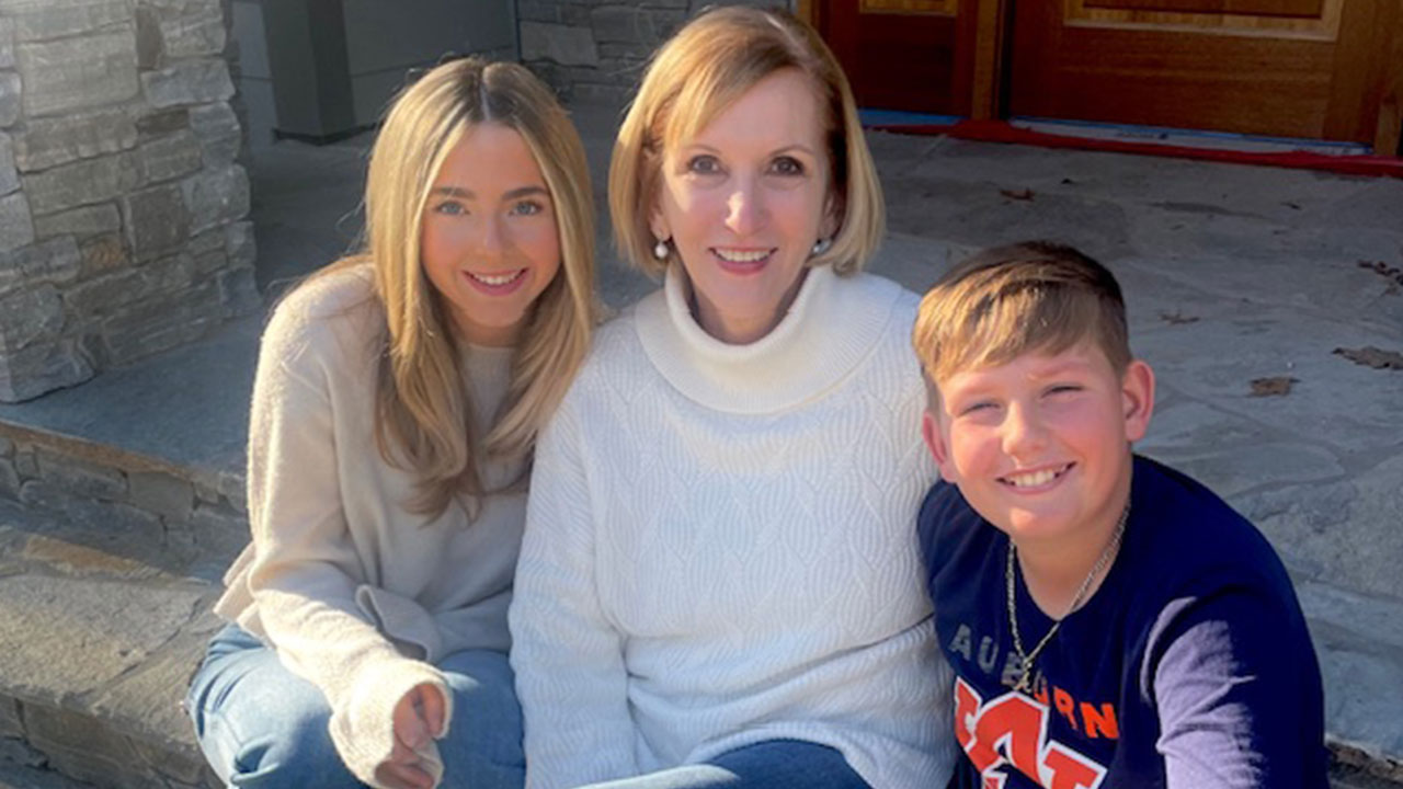 Beth Hallock is pictured outdoors with her two grandchildren