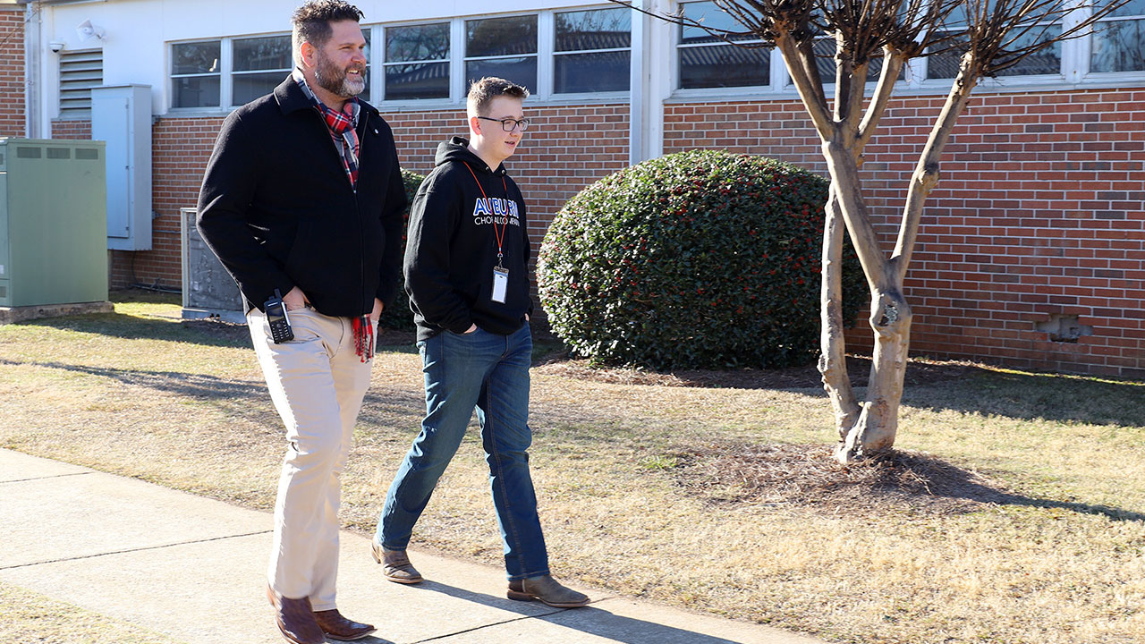 School Counselor Donnie Payne walks with a student outside