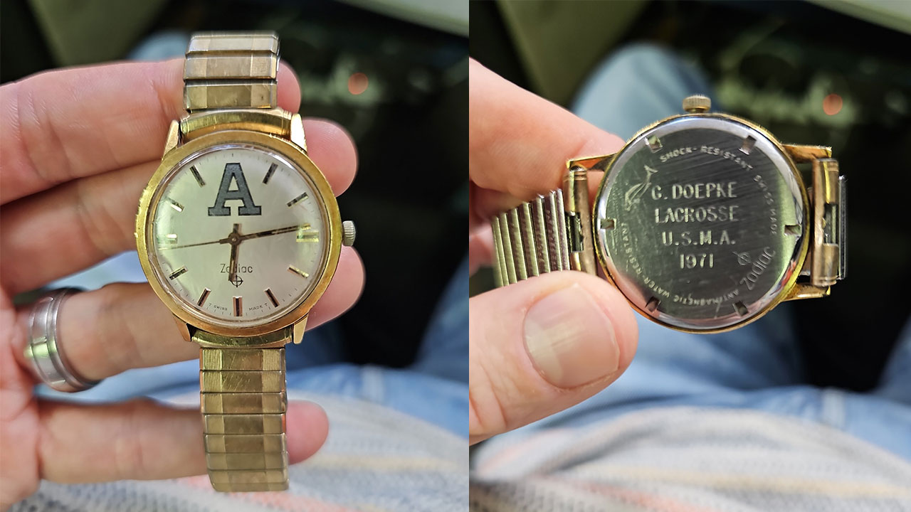 A watch is pictured front and back, side by side