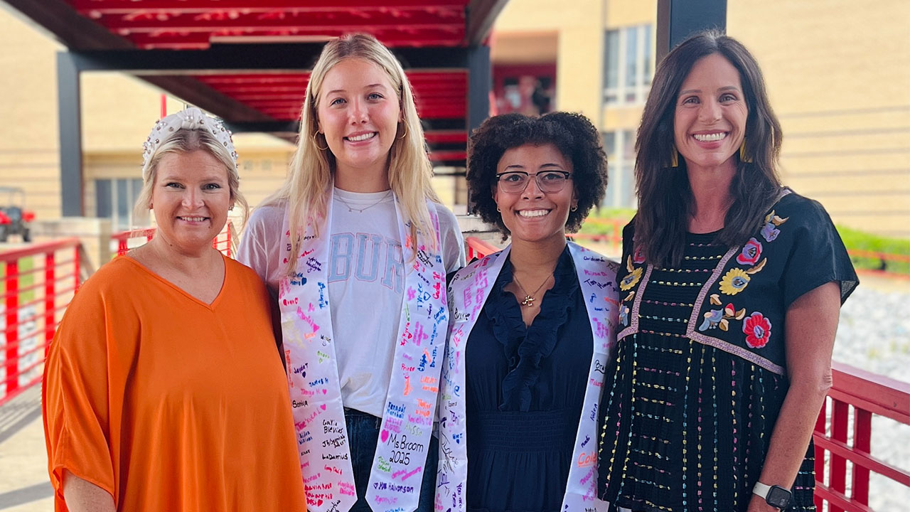 Students are pictured with staff outdoors at a local school.