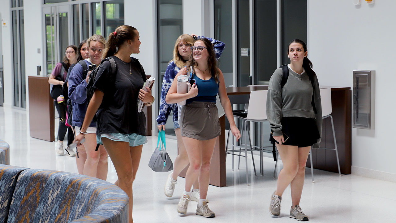 Students walking in the new building atrium