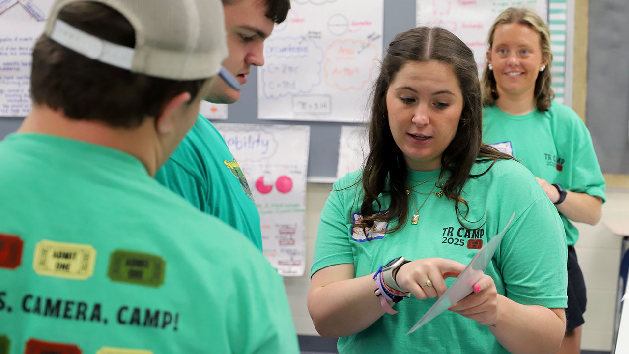 A College of Education student works with campers as part of a therapeutic recreation summer camp