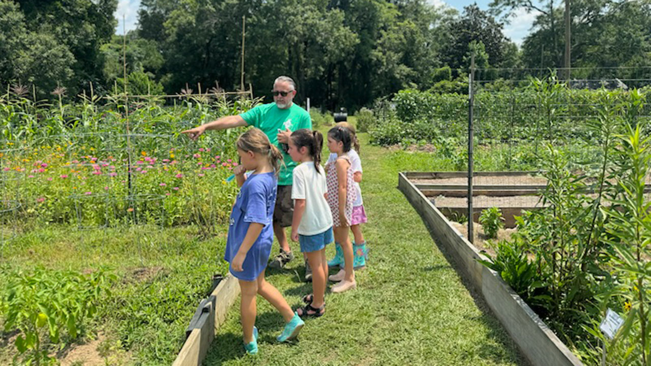 Sean Forbes and children in the garden