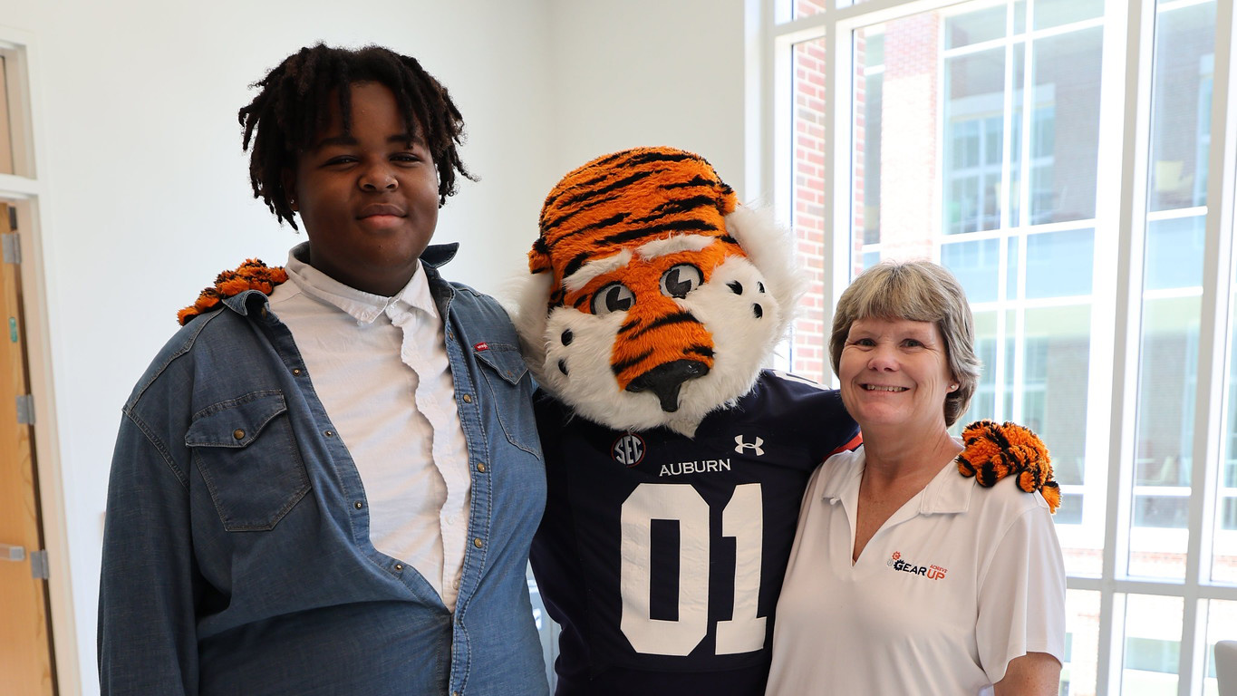 From left, Jessean Patterson, Auburn University mascot Aubie the Tiger and GEAR UP Achieve Region 11 School Liaison Susan Hudspeth pose for a celebratory photo at the closing ceremony of the GEAR UP Achieve summer residential camp at Auburn University.