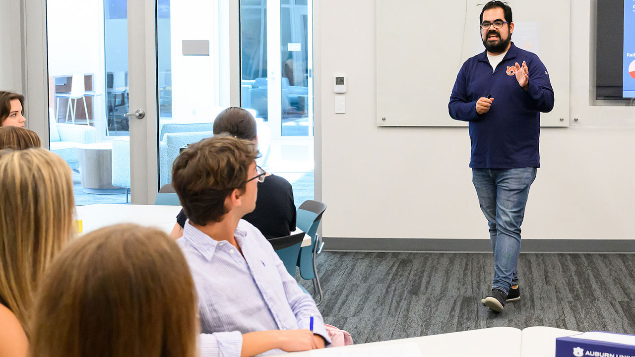 Jesus Tirado is pictured teaching to a class of students inside the College of Education building