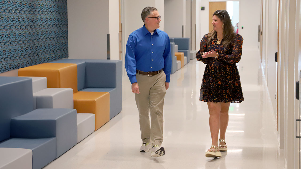 Jill Salisbury-Glennon, right, walks with former student Christopher Wyckoff down a hallway inside the College of Education