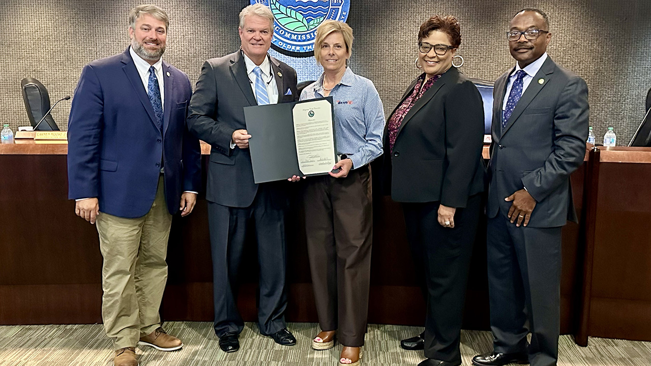 Four members of the Montgomery, Alabama County Commission flank Annette Scogin, GEAR UP Achieve Director, as she accepts their proclamation of National GEAR UP Week in Montgomery County.