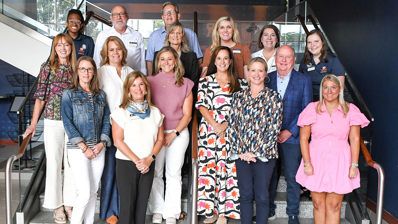 Several members of the EAGLES Engagement Council are pictured smiling in a group photo indoors.