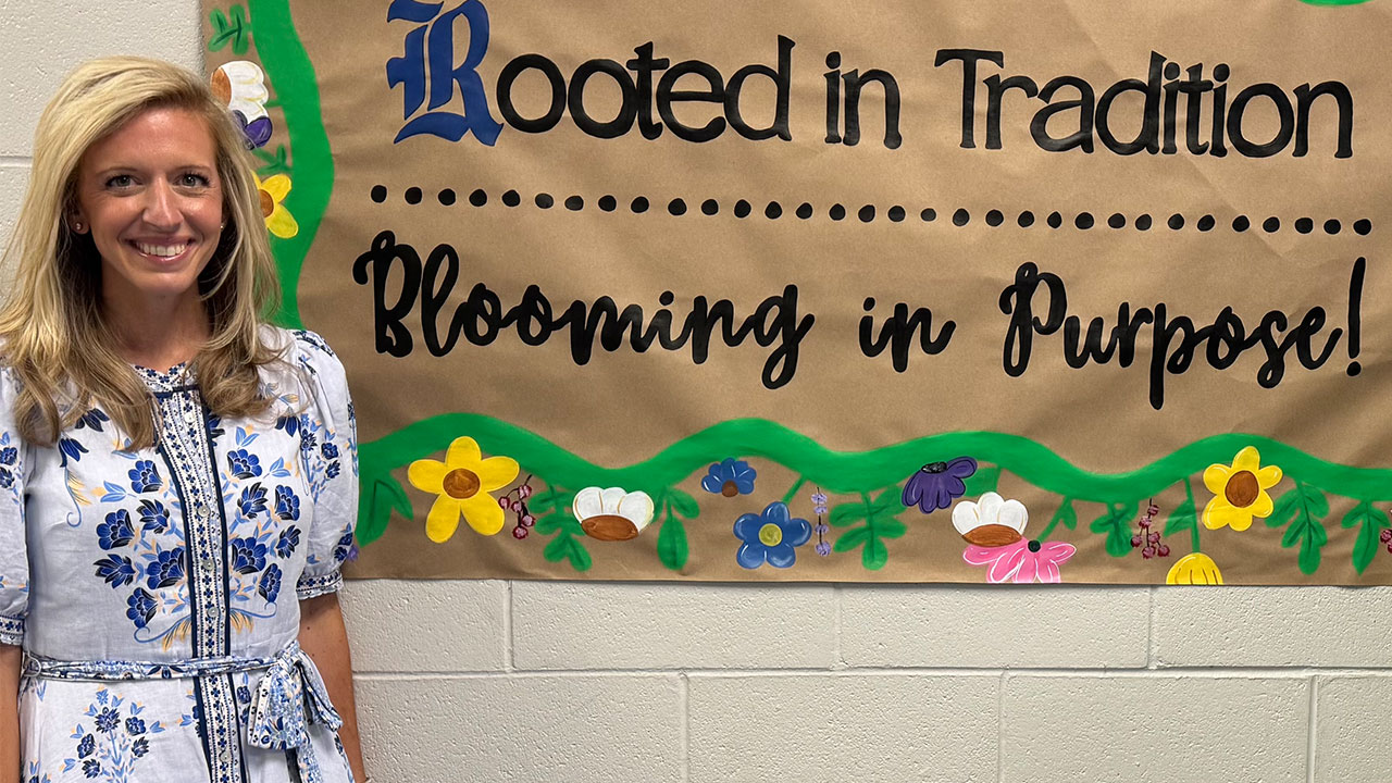 Kathryn Conradson is pictured next to the sign that reads: 