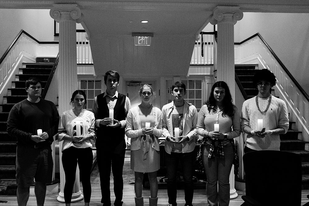 a black and white images of students standing in a line looking spooky in Cater Hall