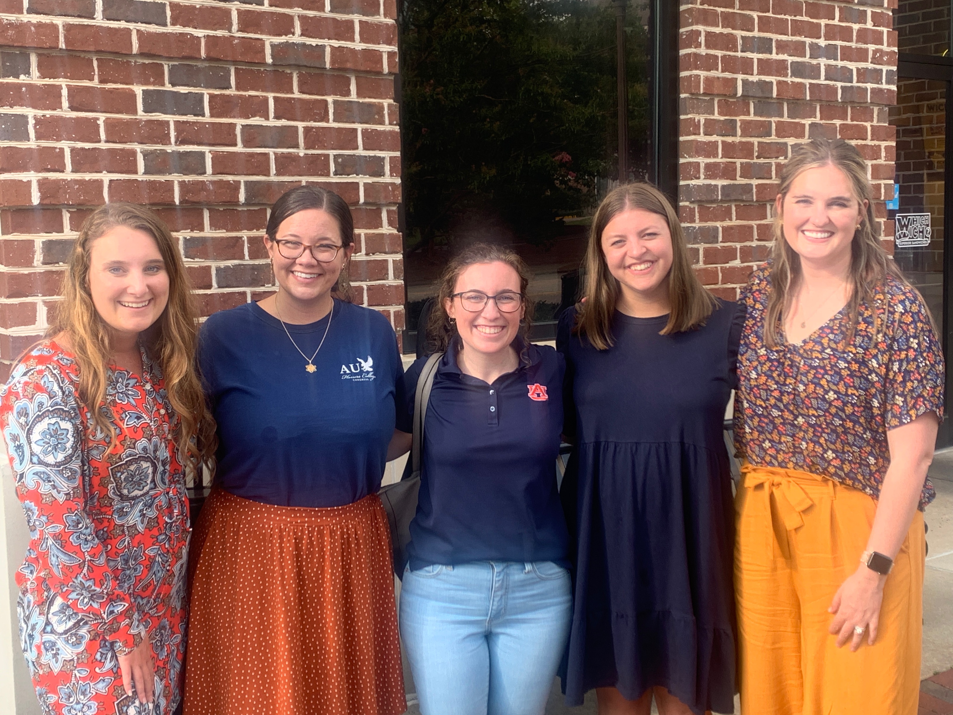 emily standing with other advisors from around campus and the honors college