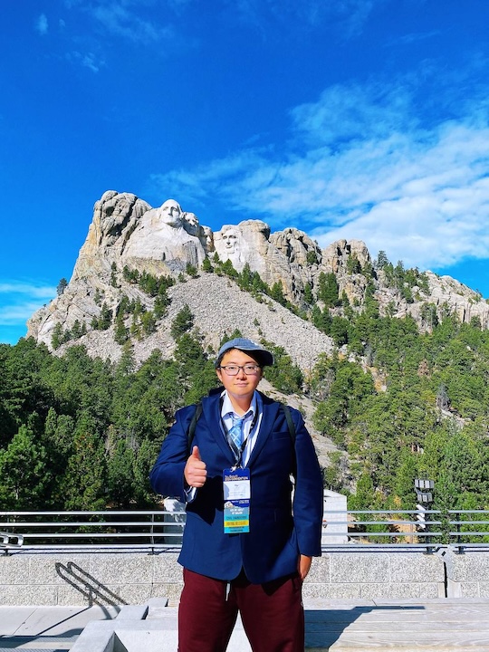 image of oliver standing in front of mount rushmore 