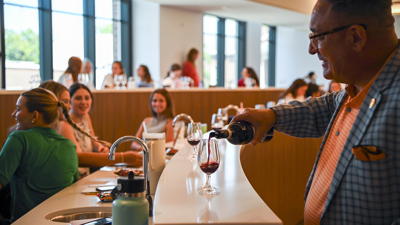 Master Sommelier Thomas Price pouring wine