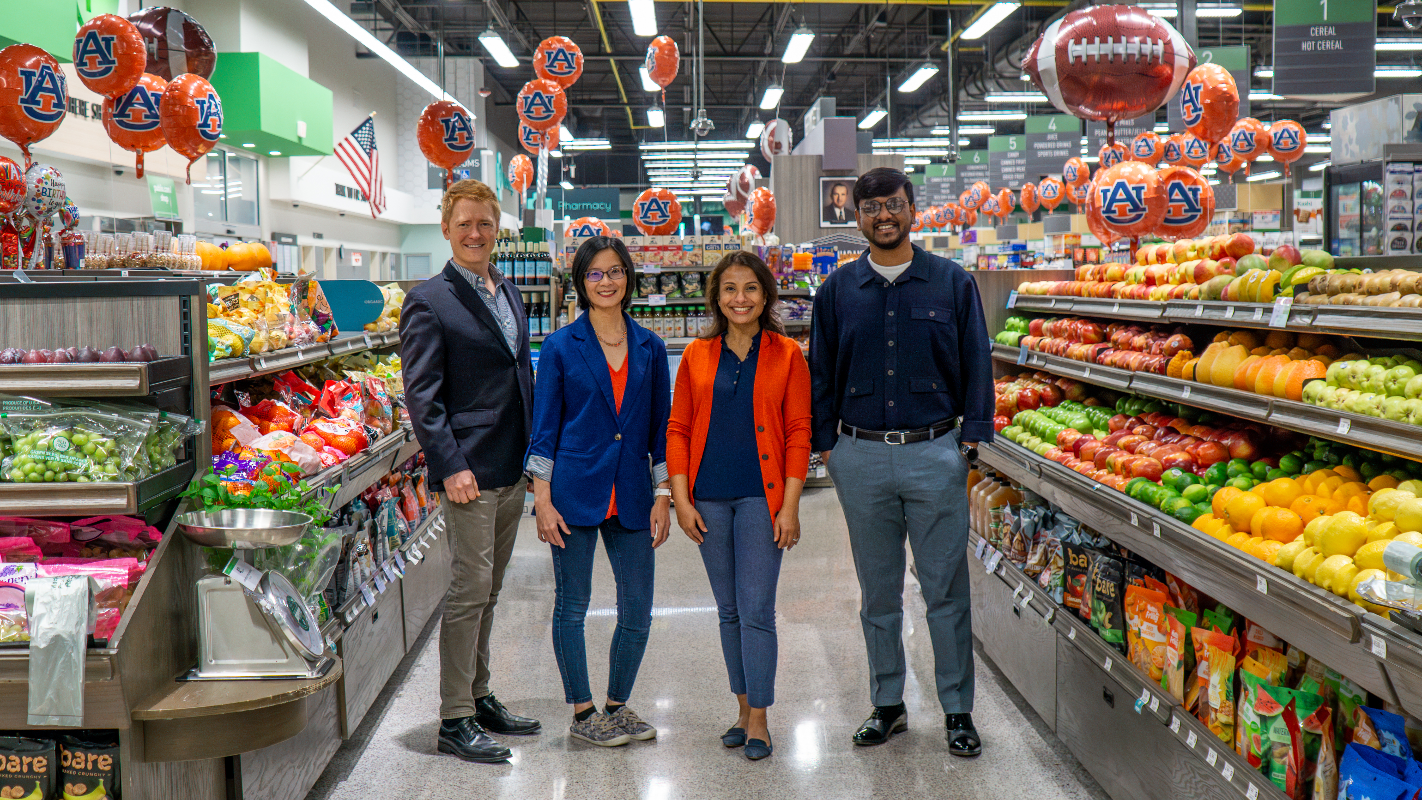 Four people stand in a grocery store aisle