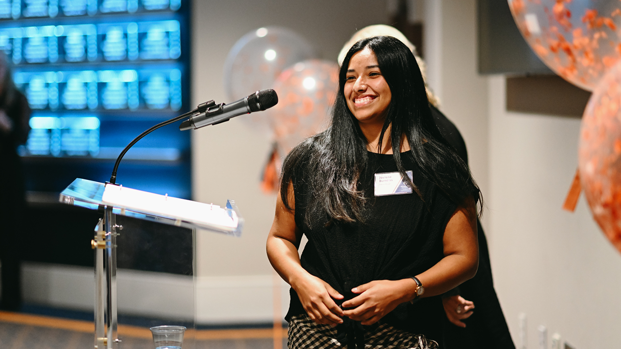 Joelene Burrows, a senior majoring in interior design in the College of Human Sciences, exits the podium after addressing attendees at the 2024 Scholarship Reception.