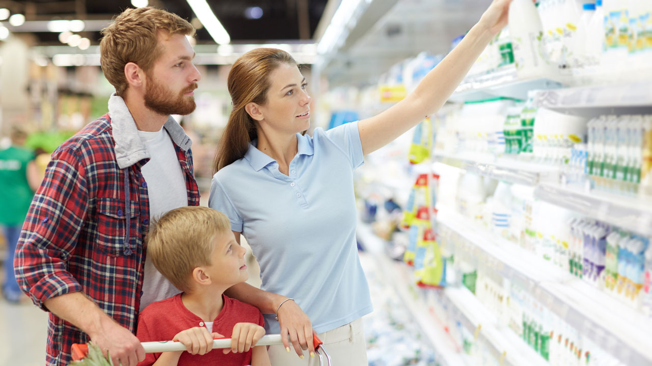 A family shops for milk at a grocery store